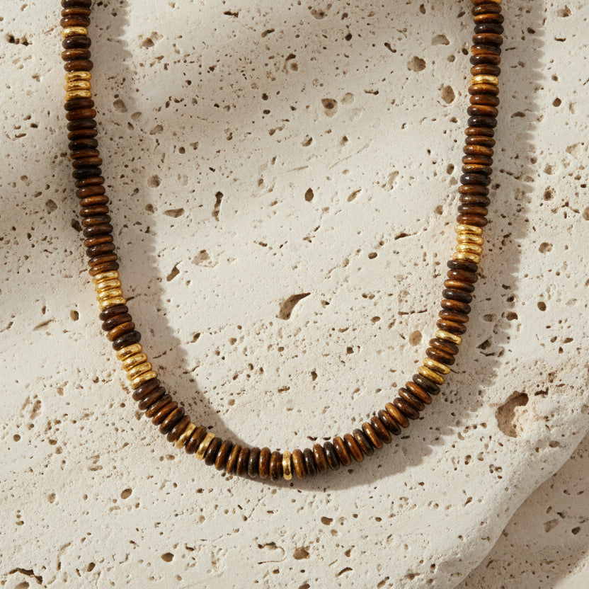 Necklace with brown and black beaded strands on a white background