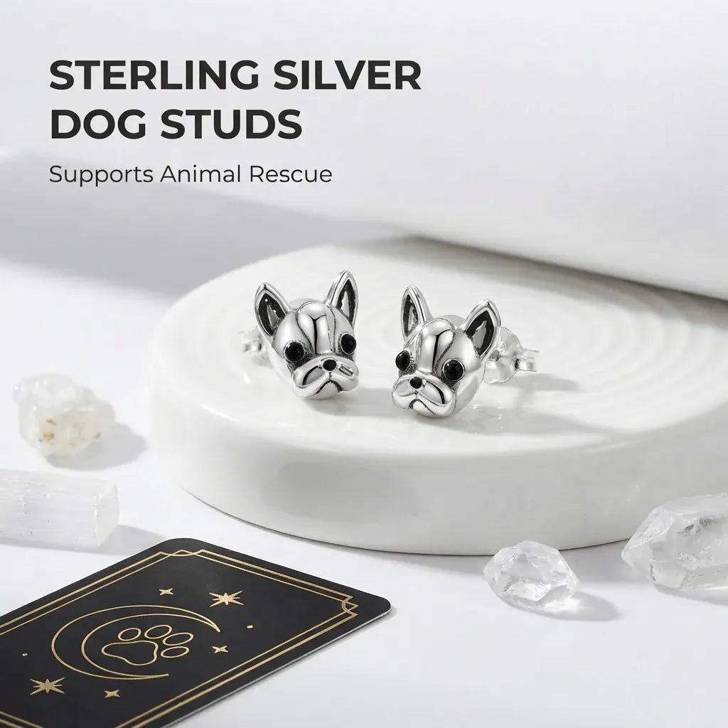 Sterling silver dog stud earrings on a white dish with text about supporting animal rescue.