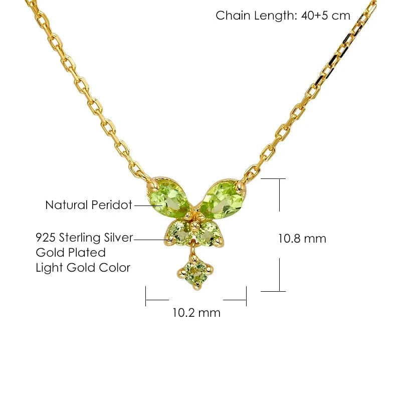 Gold necklace with green gemstones on a white background