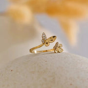 Gold butterfly ring on a stone outdoors — spirit animal jewelry for transformation