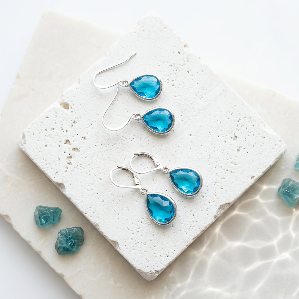 Silver Capri blue faceted glass teardrop earrings shown on shepherd's hook and leverback ear wires