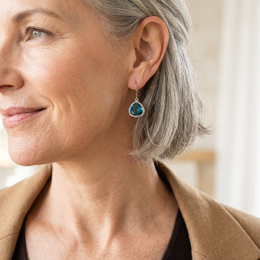 Woman wearing silver Capri blue Mini Pebble earrings in faceted glass