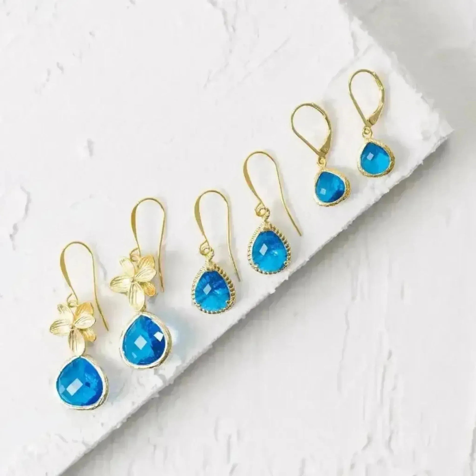 capri blue earrings with gold in three sizes of designs