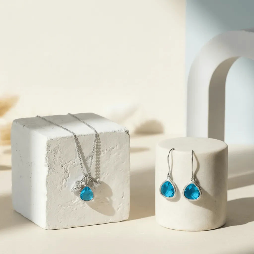 Jewelry set with blue gemstones on a white surface