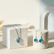 Jewelry set with blue gemstones on a white surface