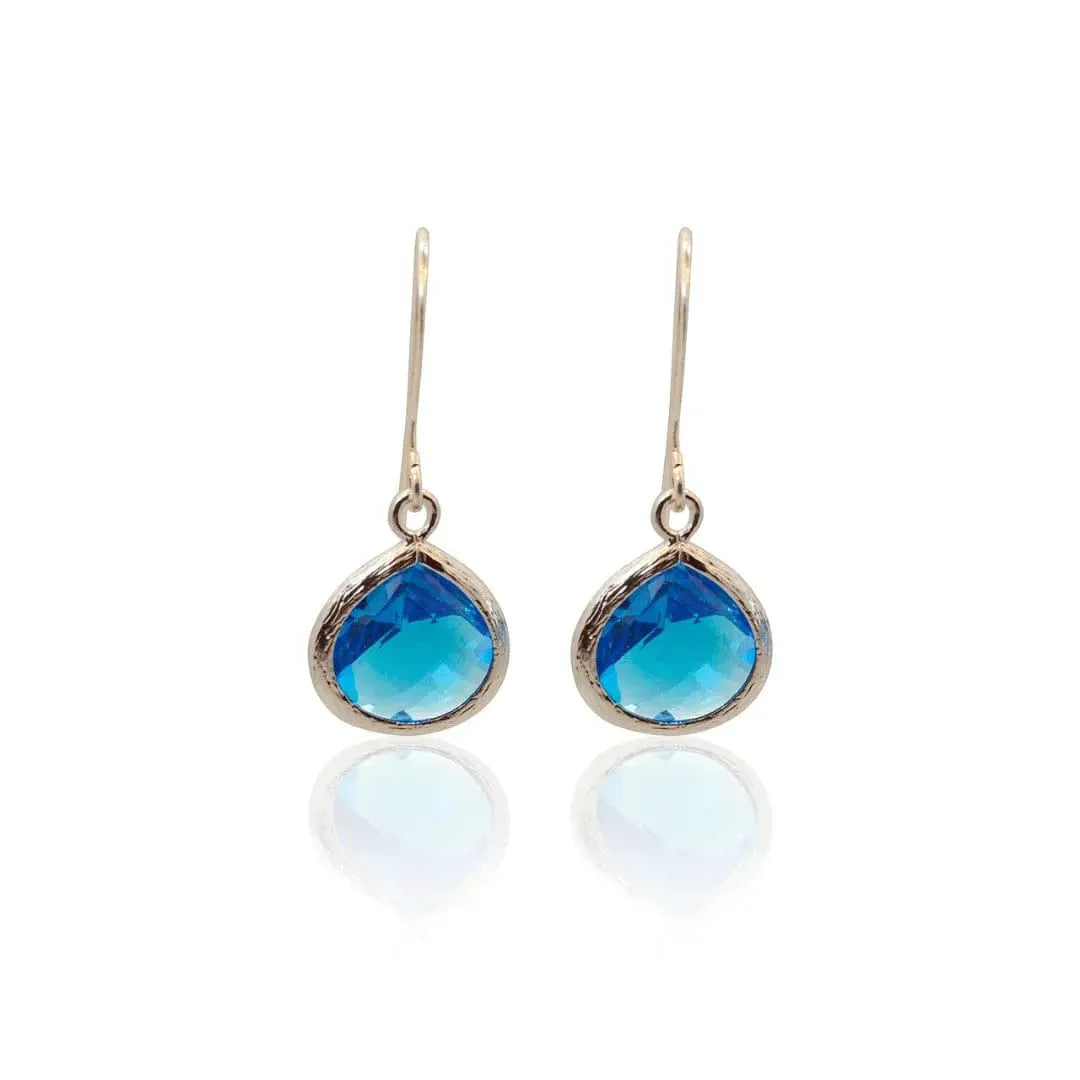 Pair of blue teardrop earrings on a white background
