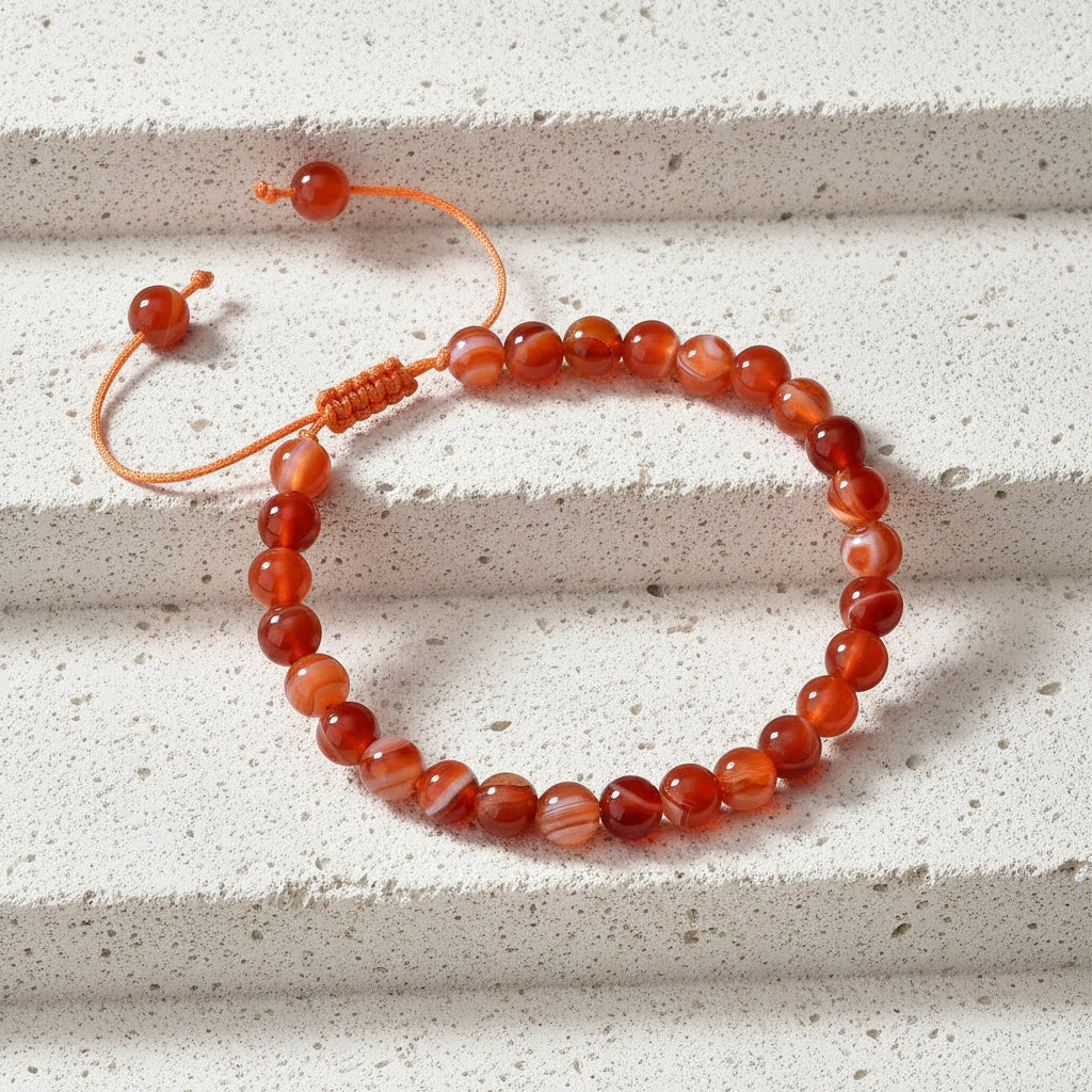 Carnelian bracelet on a wooden surface with a card describing its properties.