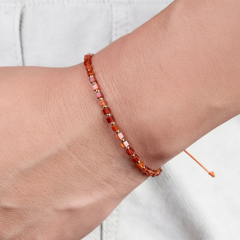 Carnelian sacral chakra wrap bracelet on the wrist — sacral chakra jewelry for creativity