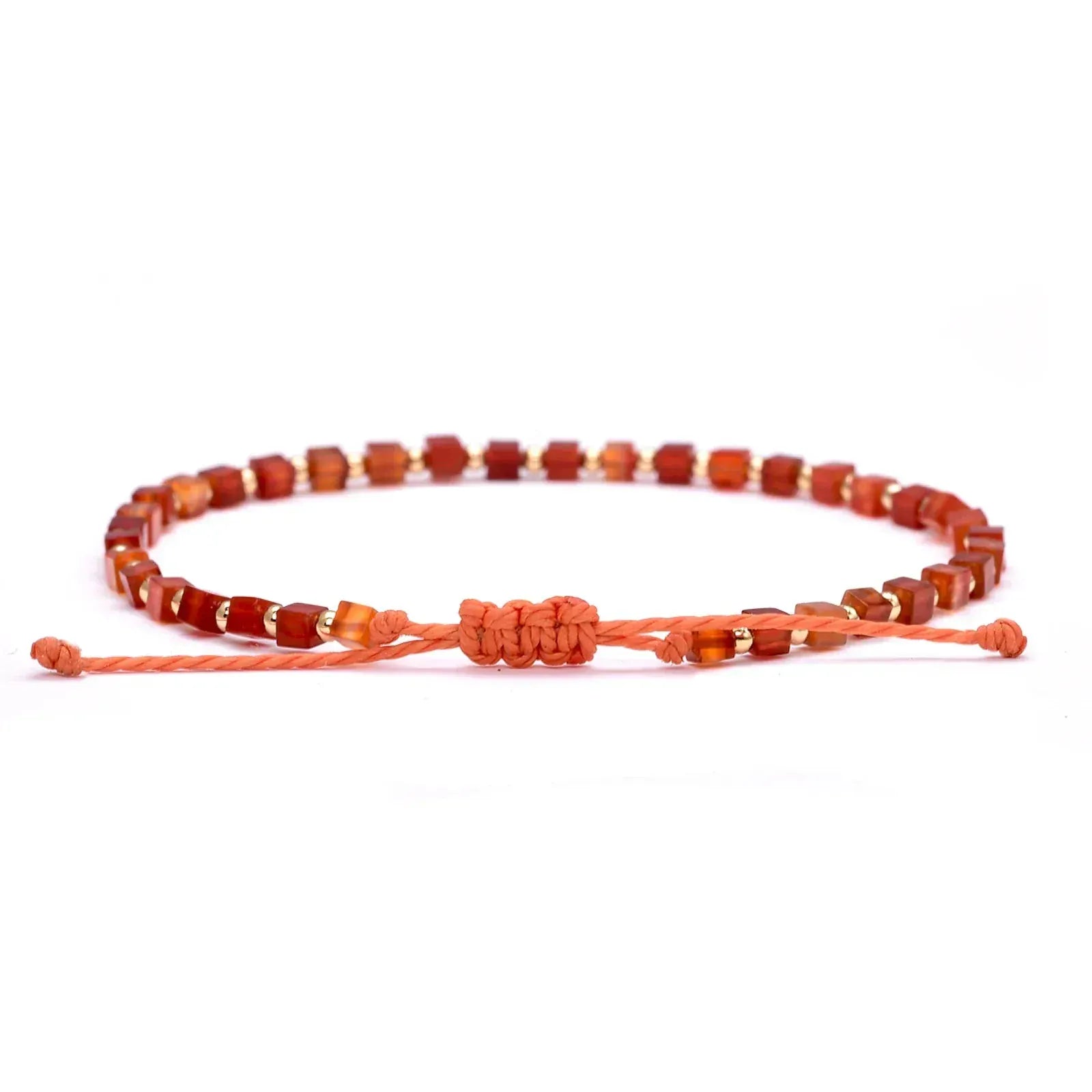 Bracelet with red and orange beads on a white background