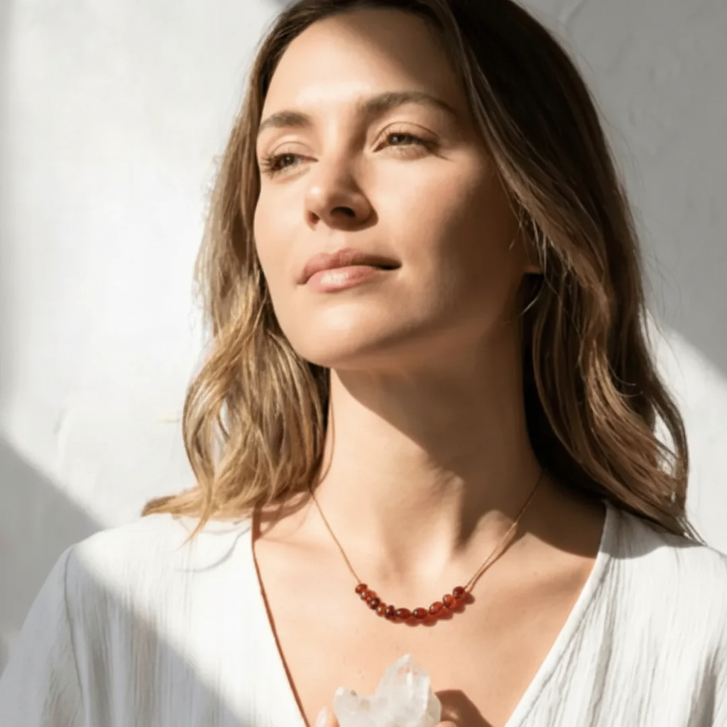 carnelian_necklace_gold Chakra_lifestyle Woman wearing a necklace with a white background