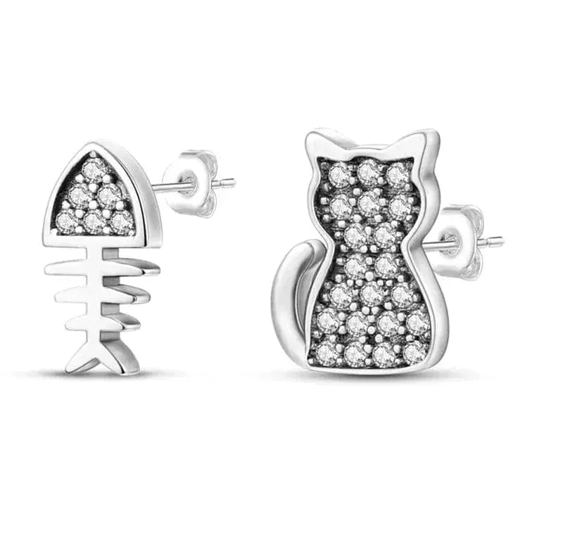 Cat-shaped silver earrings with embedded stones on a white background
