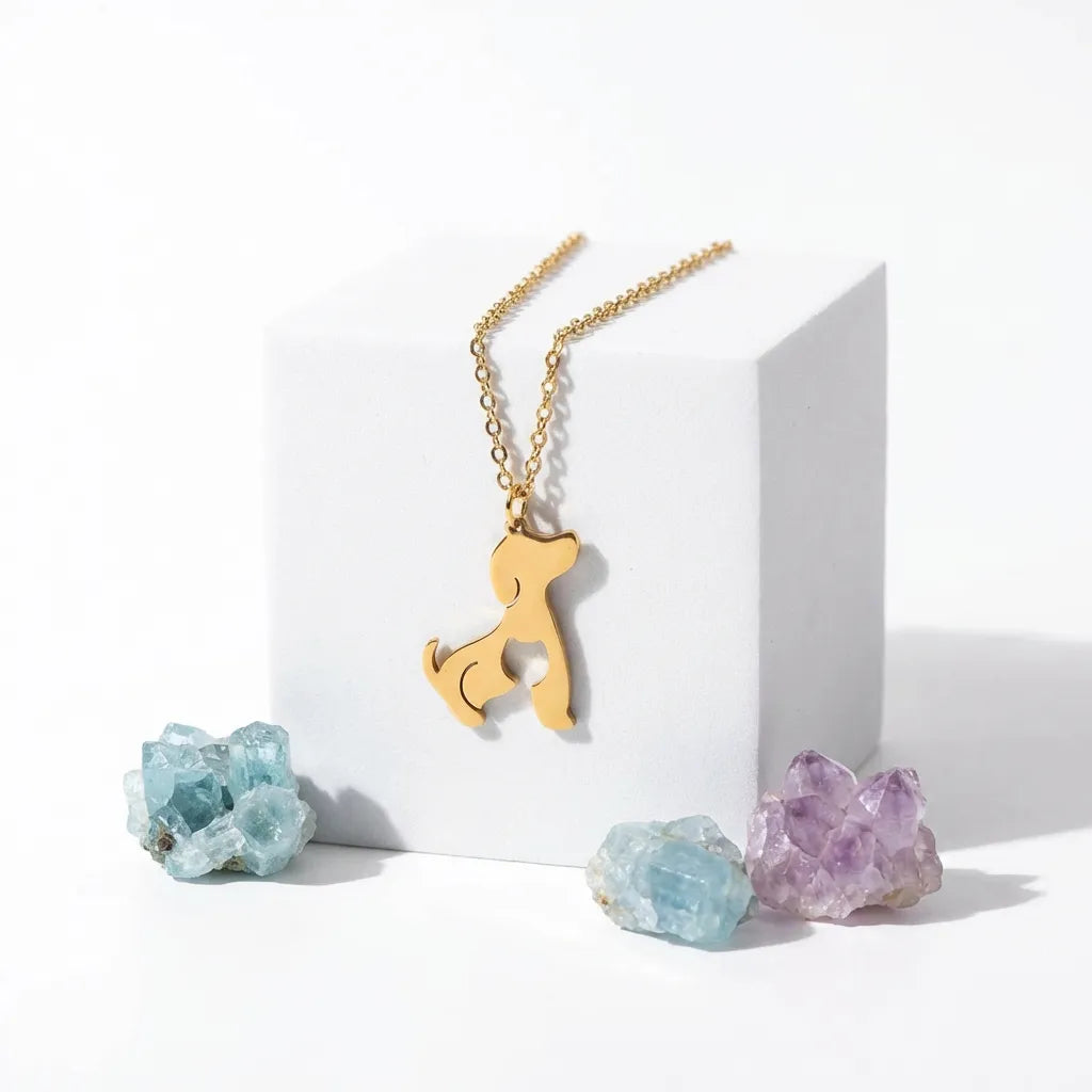 Gold cat-shaped pendant necklace with crystals on a white background