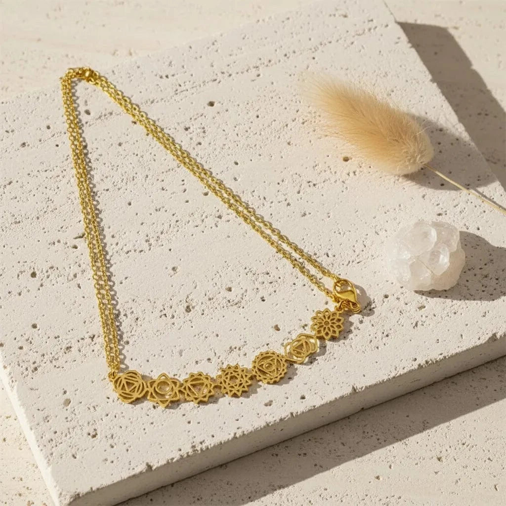 Gold necklace with floral designs on a black background