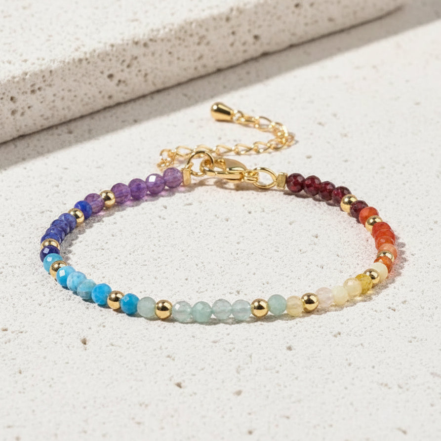 Multicolored beaded bracelet on a pink background with decorative elements.