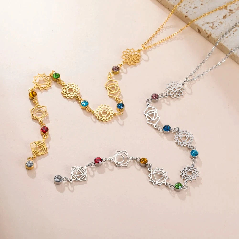 Two necklaces, one gold and one silver, with decorative elements on a beige background.