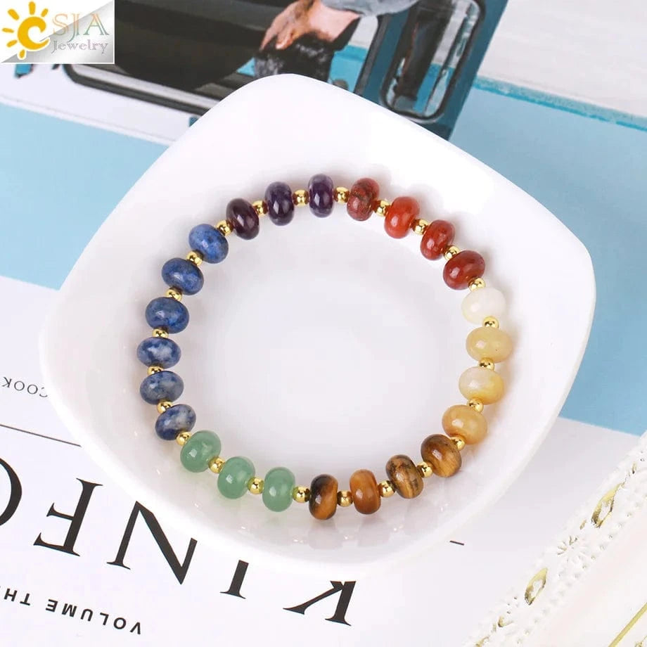 Multicolored beaded bracelet on a white dish with a magazine underneath