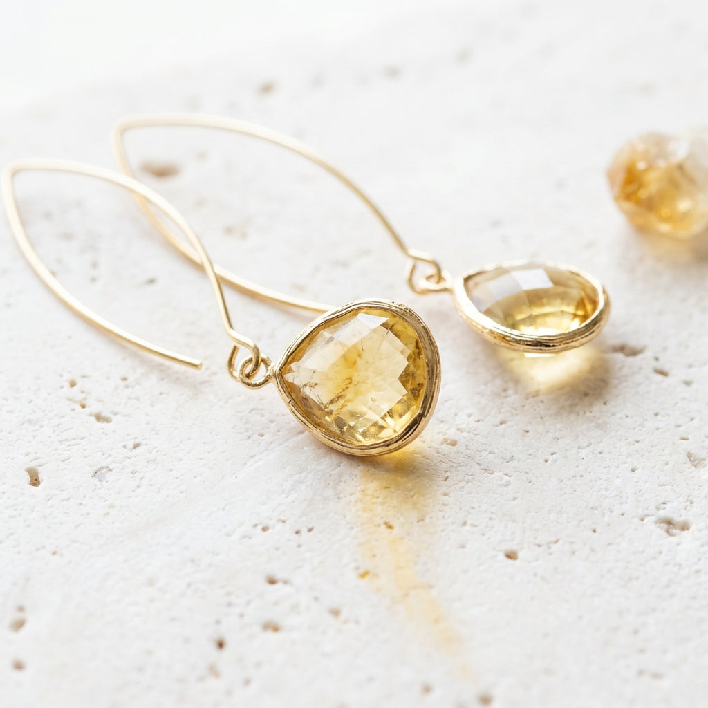 Citrine glass Elegant Pebble earrings on gold long ear wires, flat lay