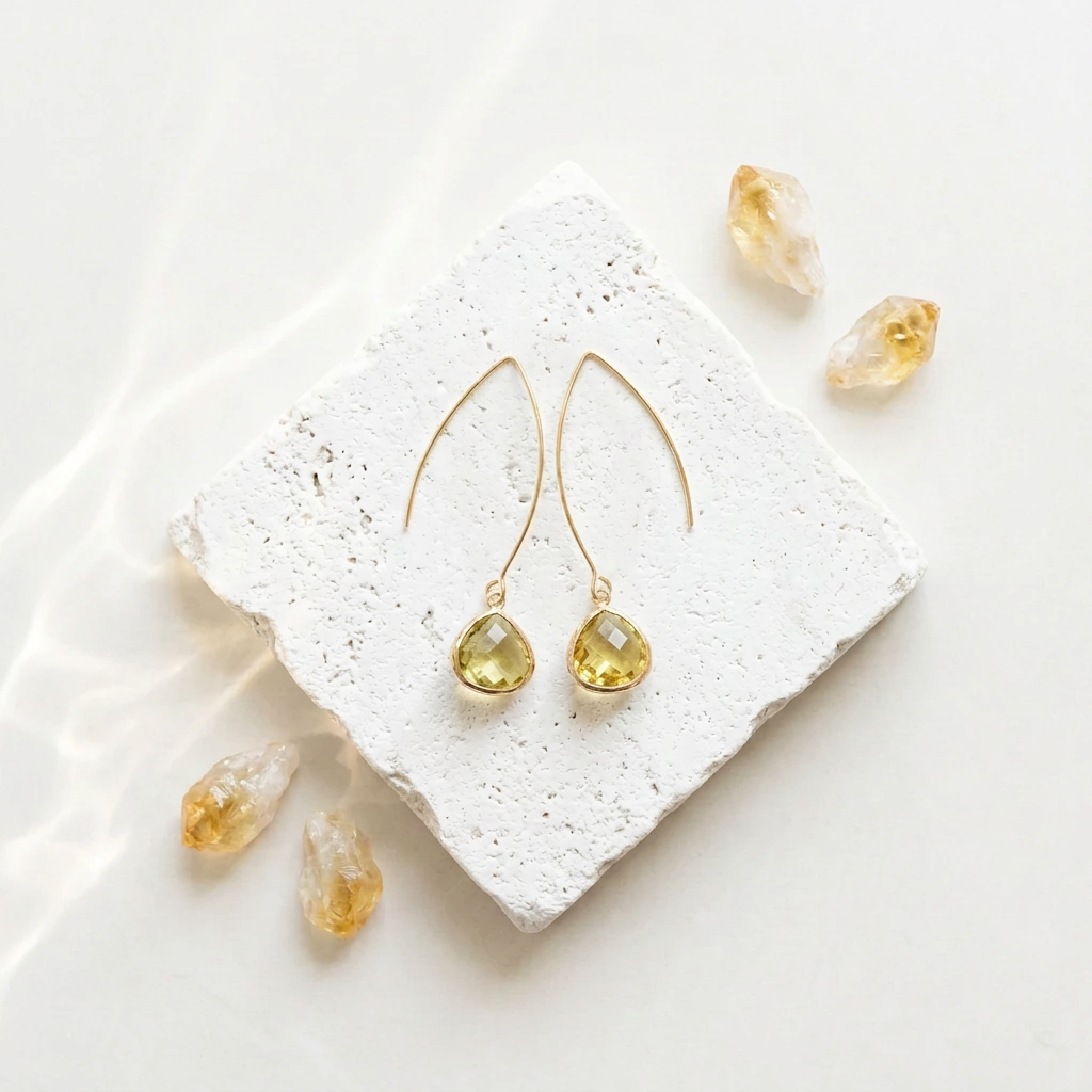 Honey yellow citrine glass pebble drop earrings in gold, flat lay