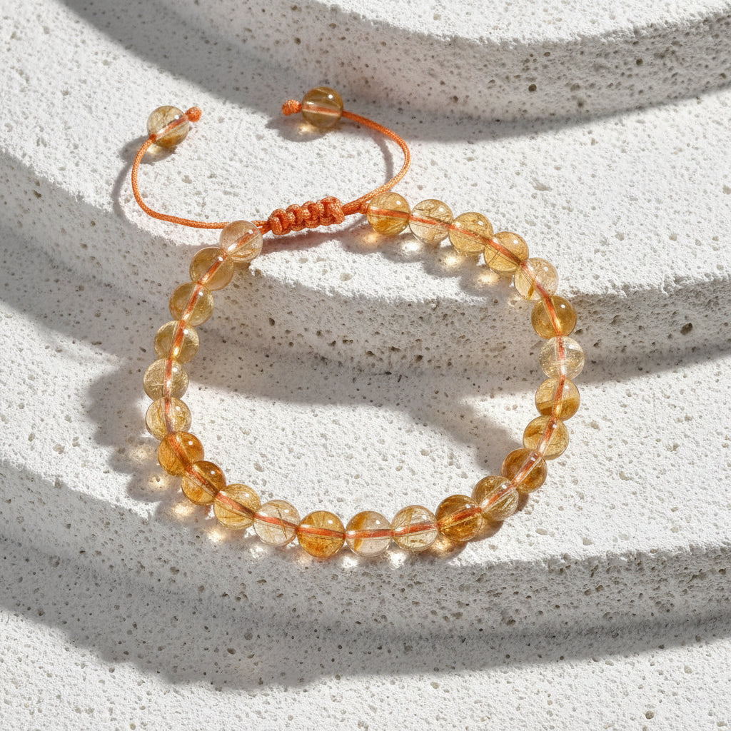 Citrine bracelet on a card with energy, confidence, positivity text on a wooden surface