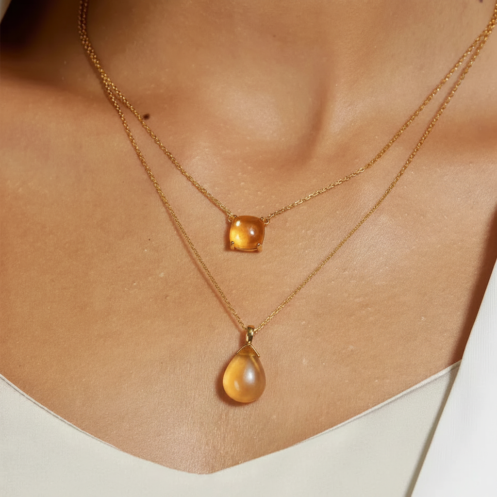 lifestyle image of woman wearing citrine and gold necklaces
