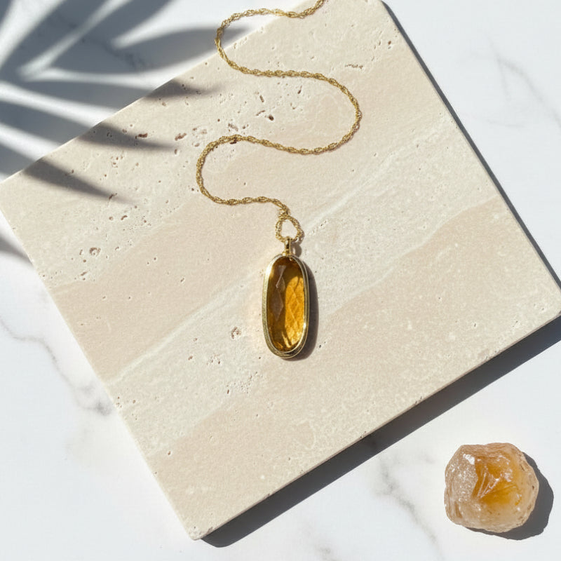 Honey-gold natural citrine pendant necklace with gold-plated bail, flat lay — November birthstone