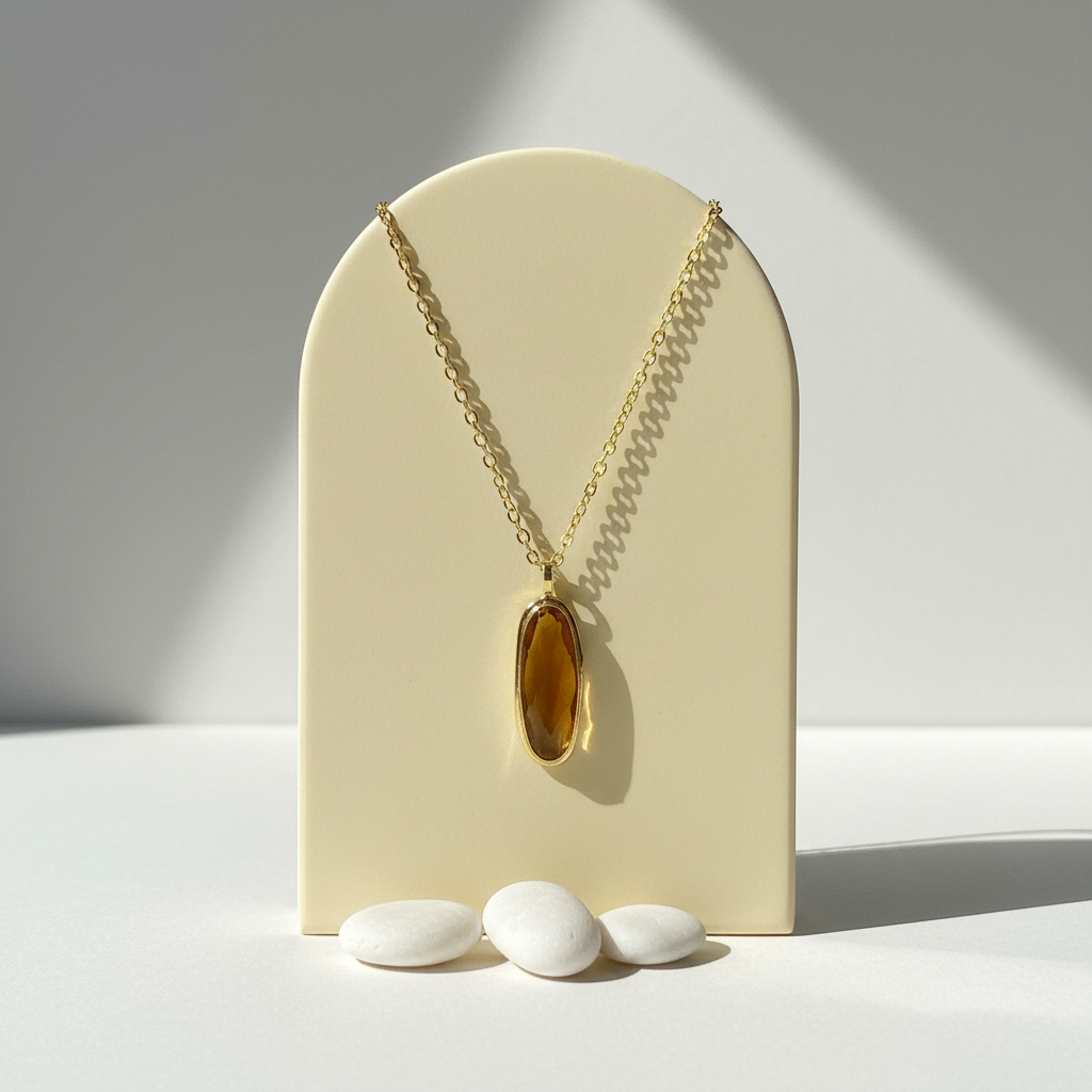 Natural citrine pendant necklace with gold-plated bail hanging against a soft neutral background
