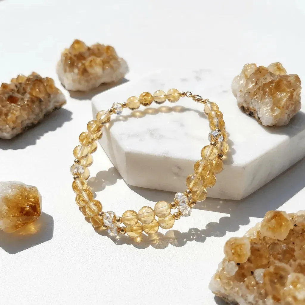 Bracelet with yellow beads on a white surface with crystal rocks