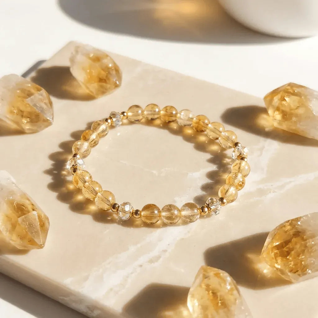 Yellow beaded bracelet on a light stone surface with citrine crystals