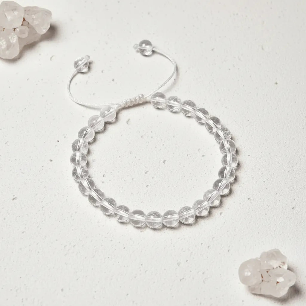 Clear beaded bracelet on a light gray background with crystal-like stones.