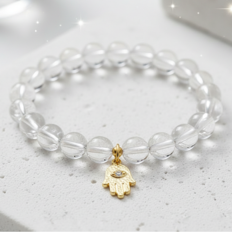 Clear quartz bracelet with a gold hamsa charm — add-on symbol charm for protection