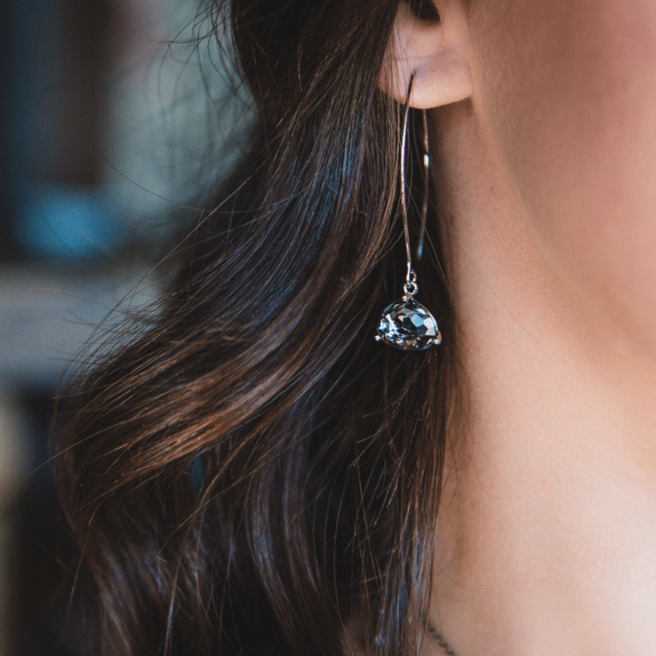 earrings on woman with brown hair