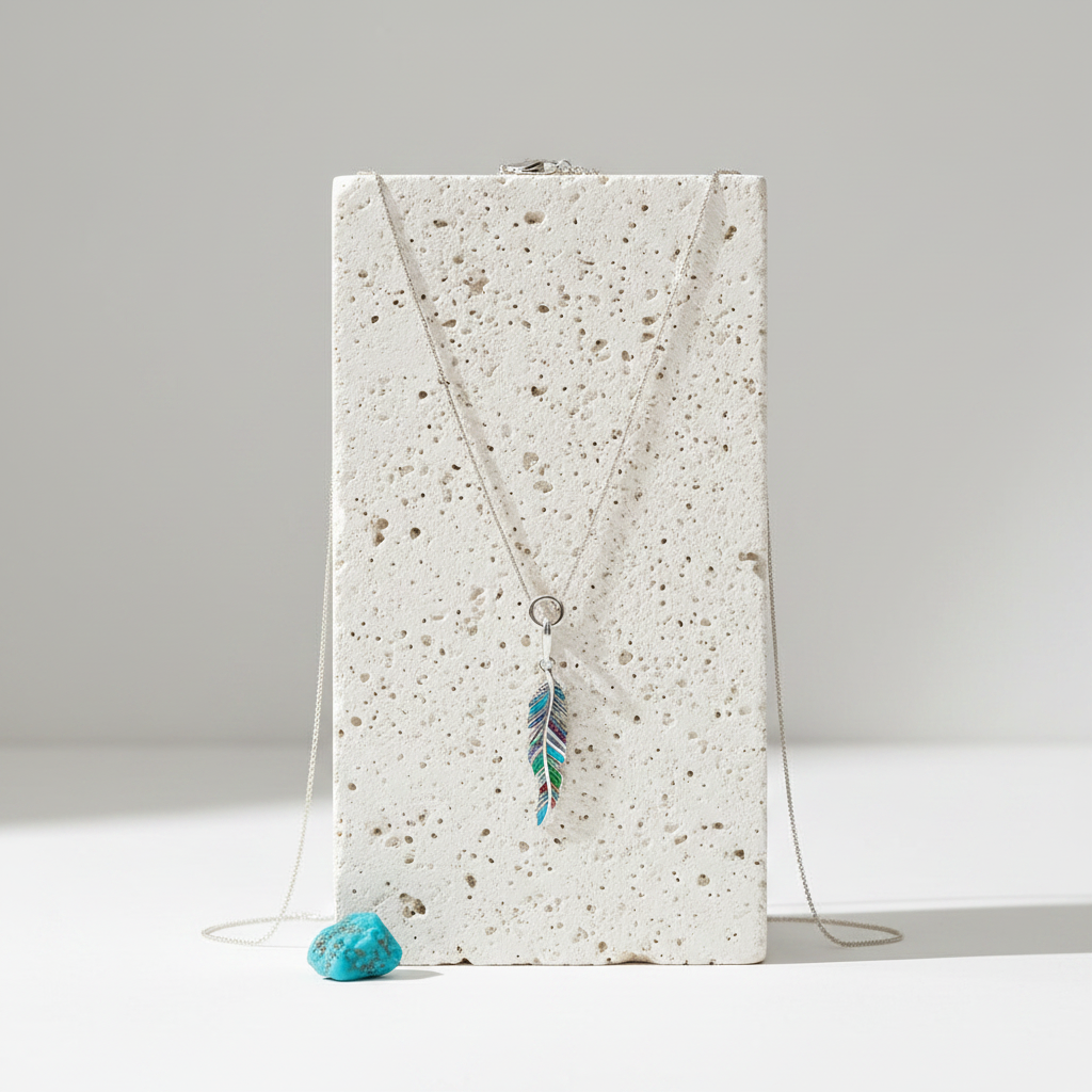 Sterling silver feather pendant with colour detail on rope chain — air element jewellery for lightness