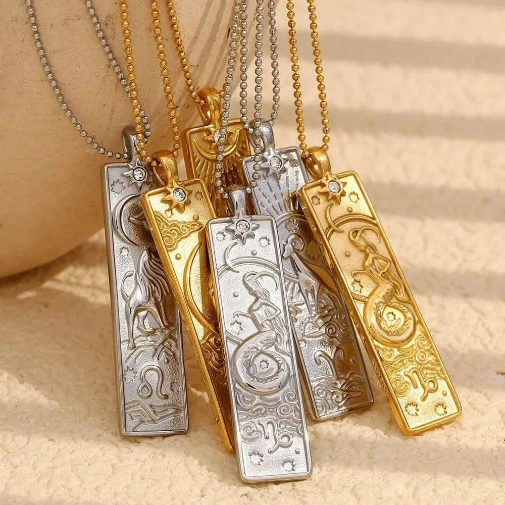 Gold and silver necklaces with intricate designs on a beige background