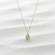 Gold necklace with a small pendant on a white background