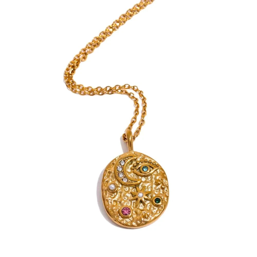 Gold necklace with a decorative pendant on a white background