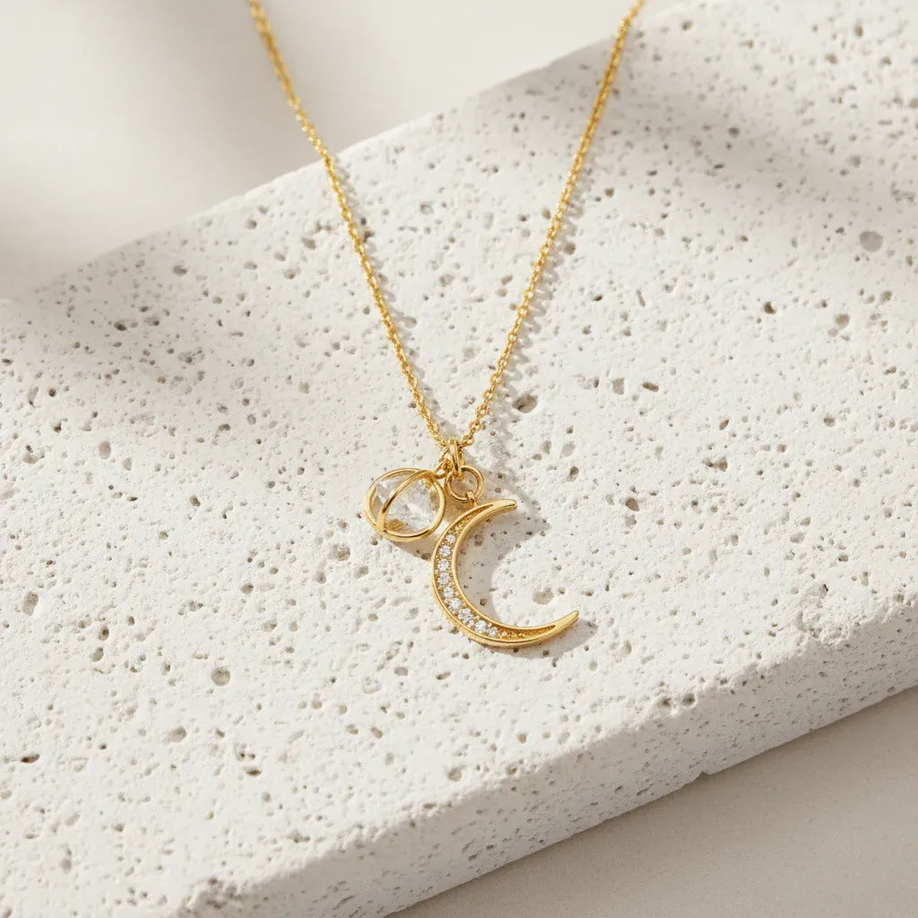 gold necklace against light flat lay background
