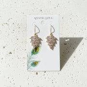 Gold earrings on a 'Mystic Soul' branded card