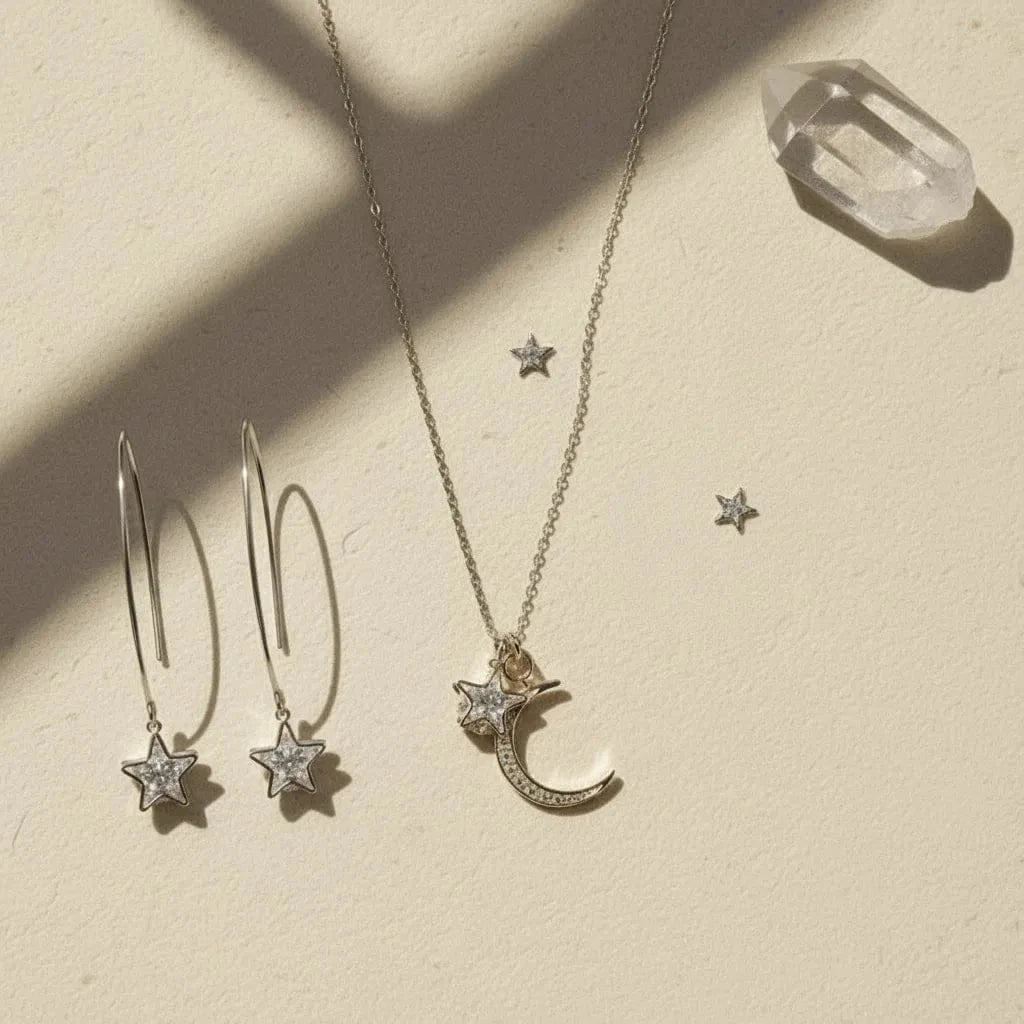 Silver jewelry set with star-shaped earrings and a necklace on a beige surface.