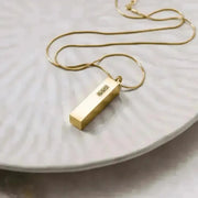 crystal vial necklace in gold