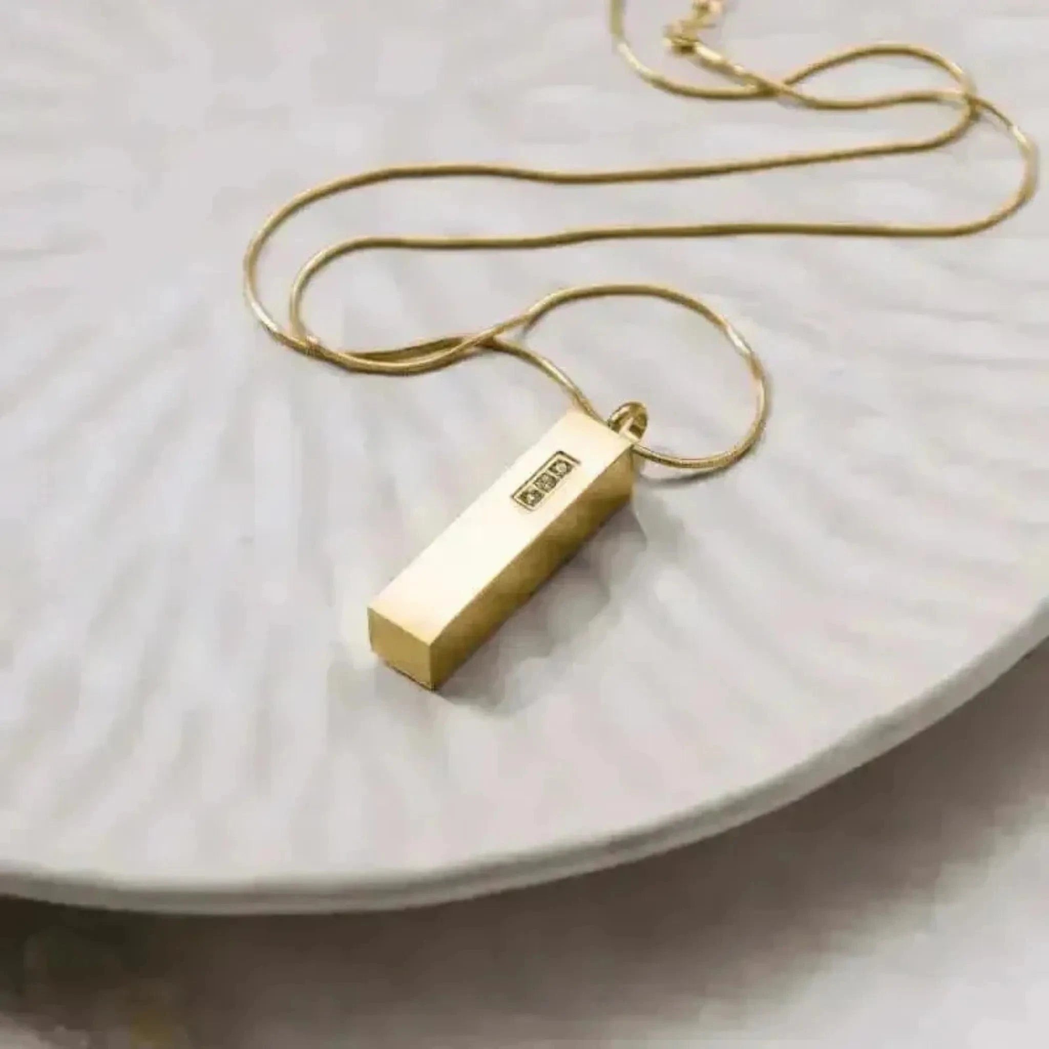 crystal vial necklace in gold