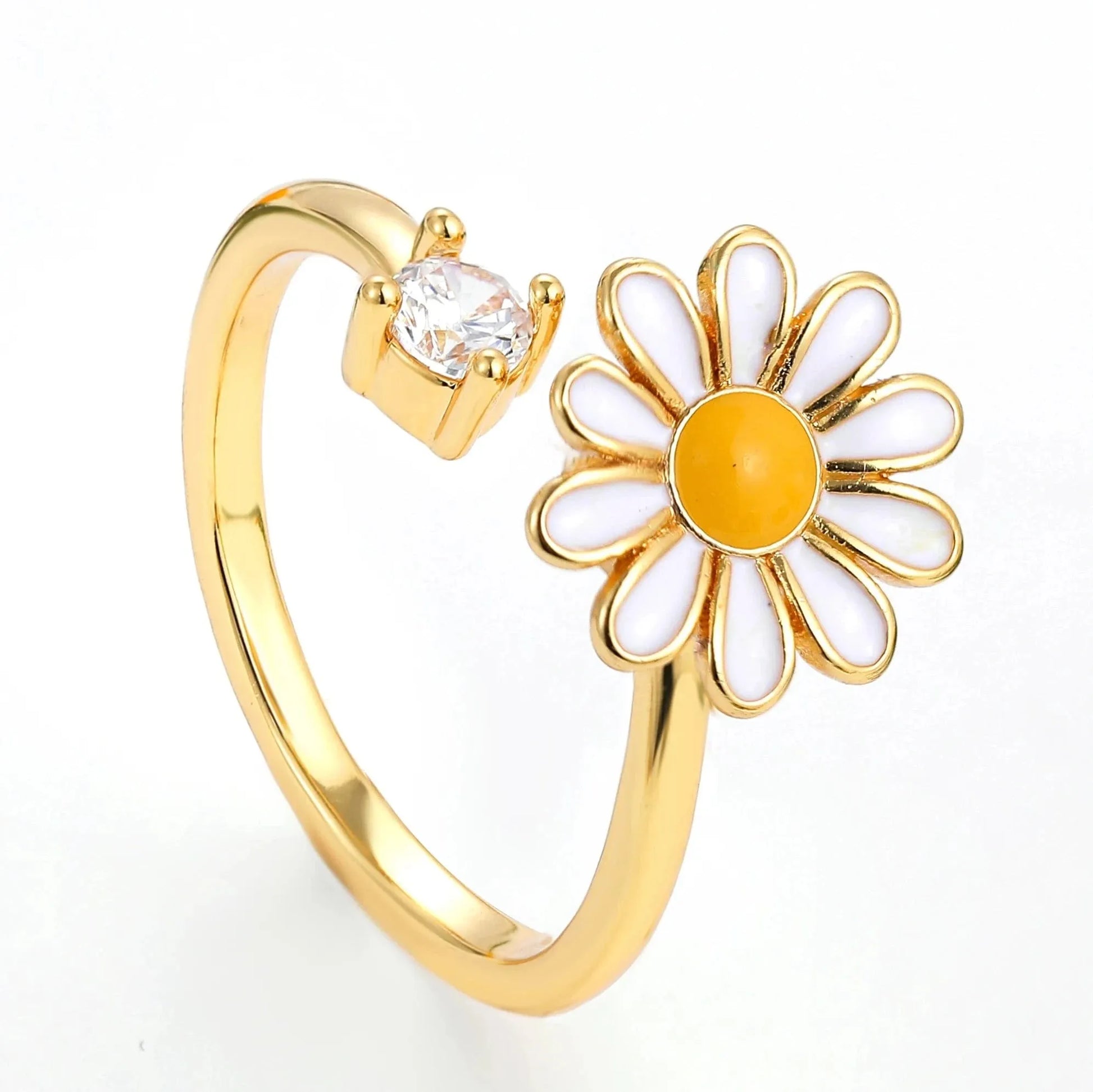 Gold ring with a daisy flower design on a white background