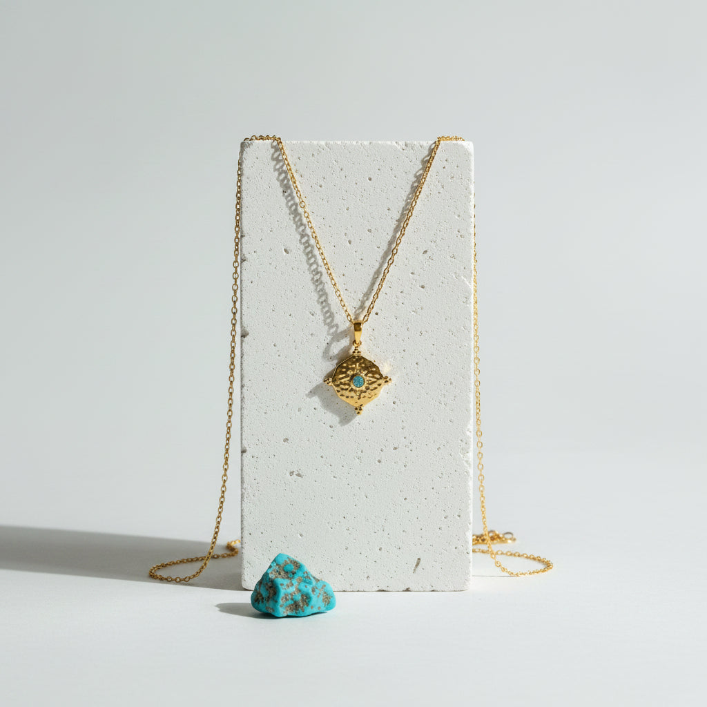 Gold hammered medallion necklace with light blue CZ centre, December birthstone jewelry