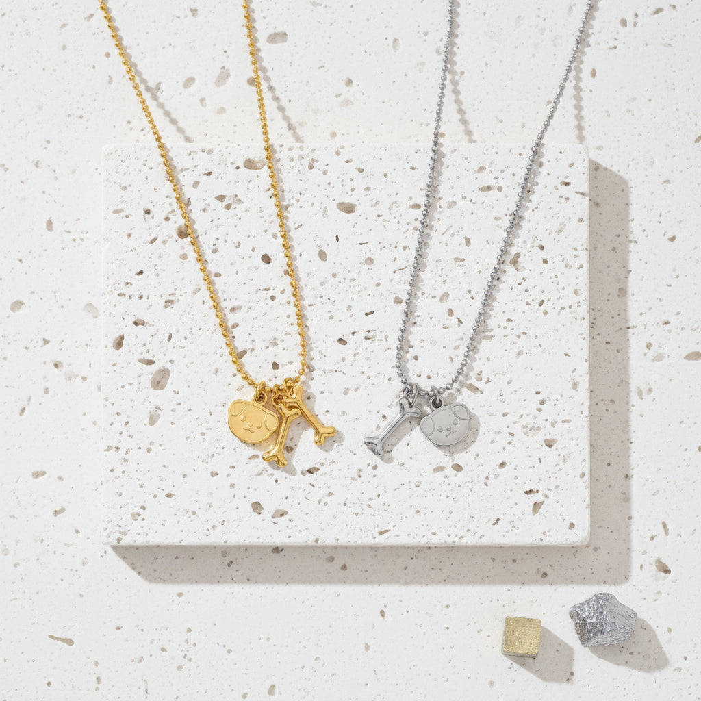 Dog bone medallion necklace in gold and silver tone side by side — Crystals & Paws rescue jewellery for loyalty
