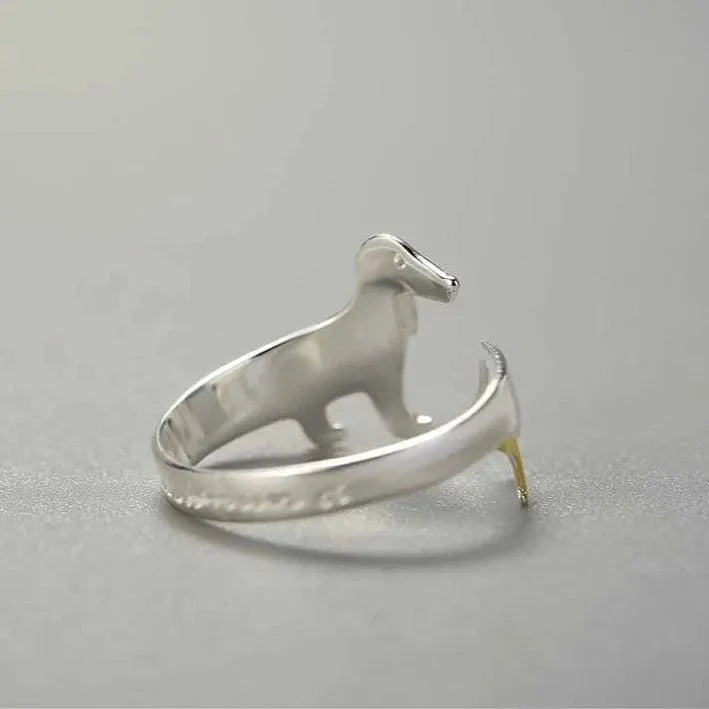 Silver dog-shaped ring on a gray background