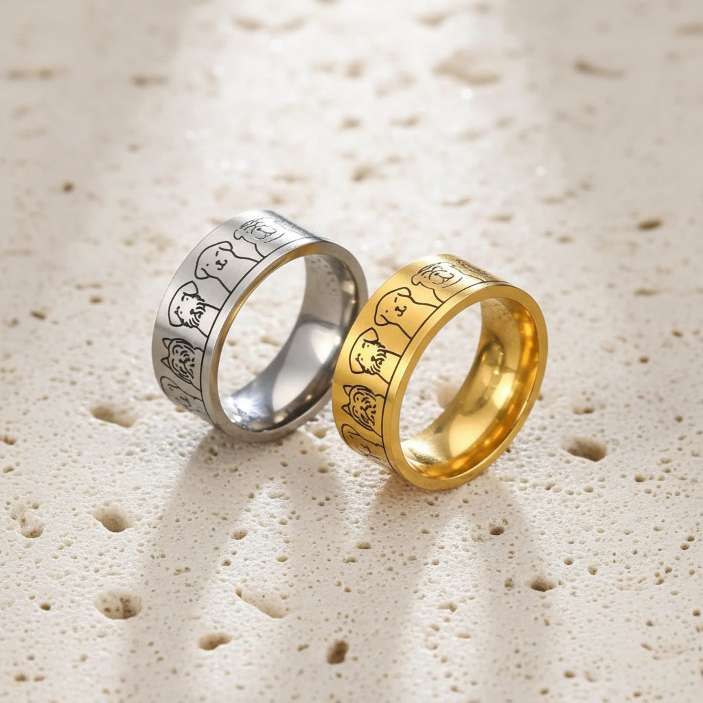 Two rings, one gold and one silver, on a dark textured surface