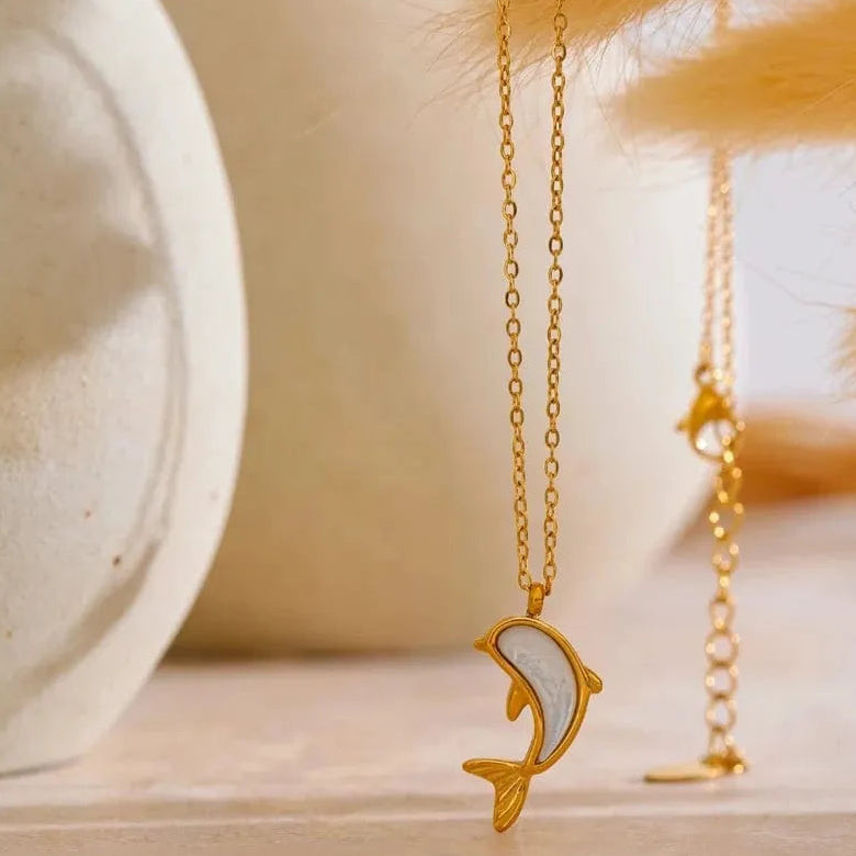 Gold necklace on a wooden surface with a blurred background