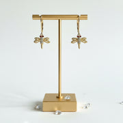 Gold crystal dragonfly leverback earrings with red eyes — spirit animal jewelry for transformation