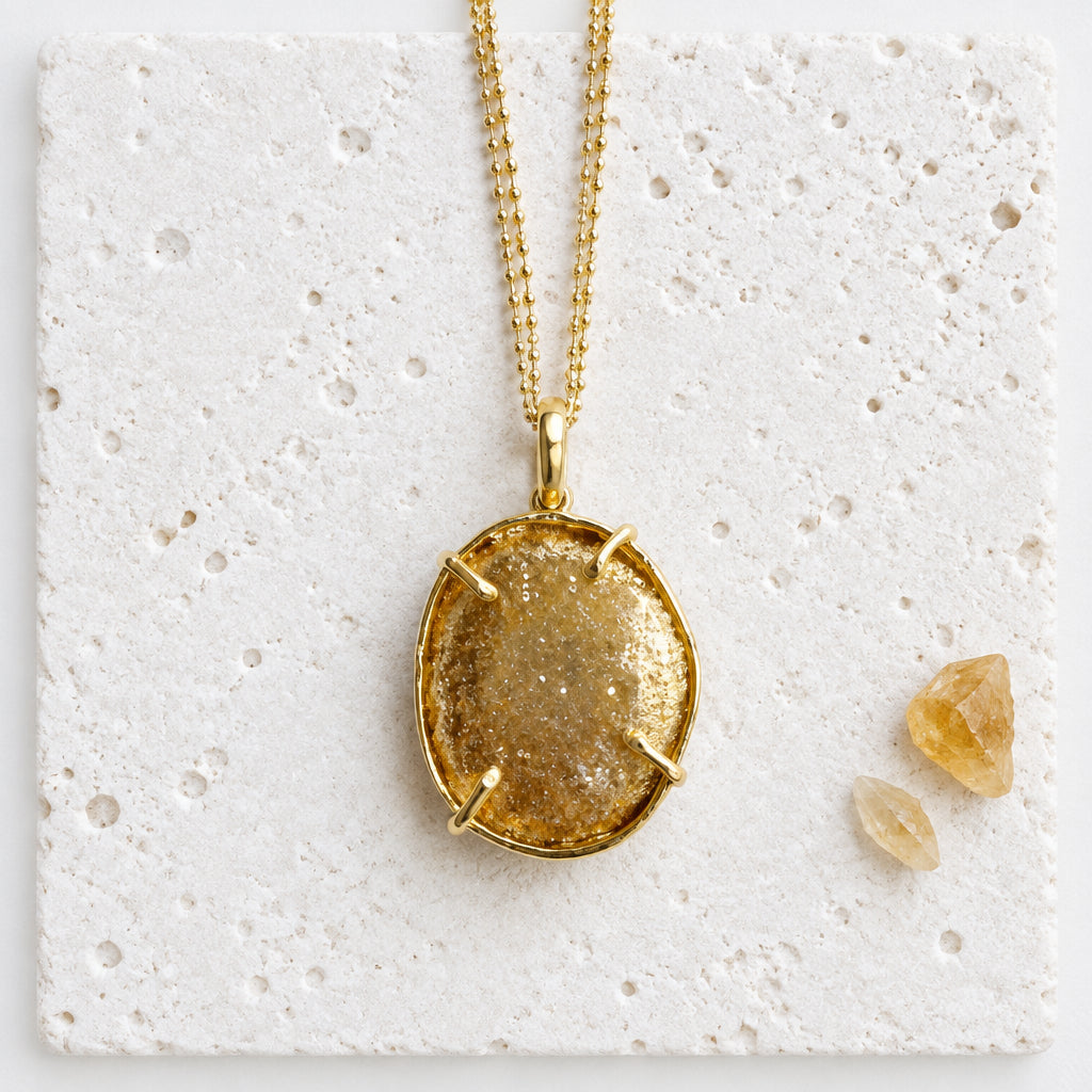 Back of the druzy agate pendant showing the gold-plated bezel that cups the stone