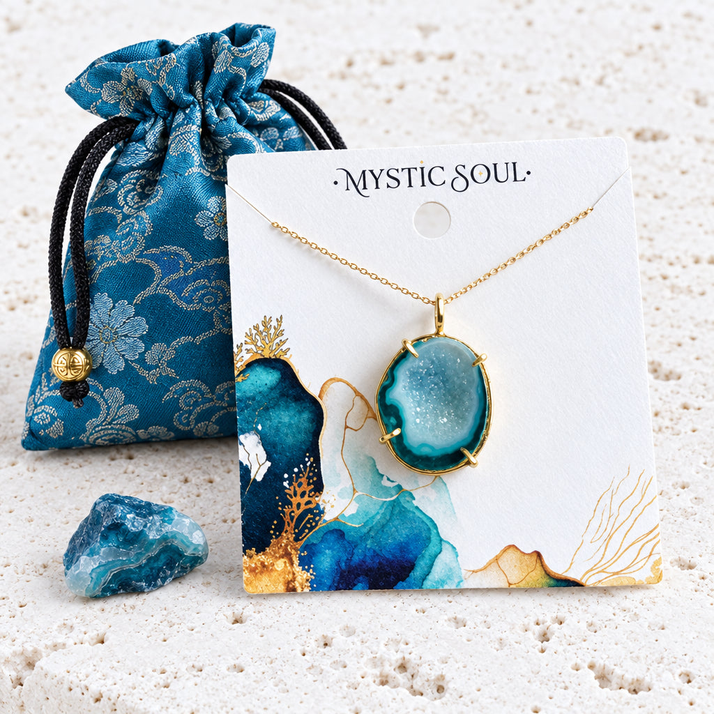 Blue druzy agate necklace on a Mystic Soul Jewelry card beside a blue gift pouch