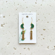 Pair of gold and green earrings on a 'Mystic Soul' card 